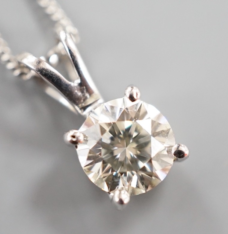 A modern 750 white metal and solitaire diamond set pendant, overall 14mm, on an 18ct white gold fine link chain, 44cm, gross weight 3.3 grams